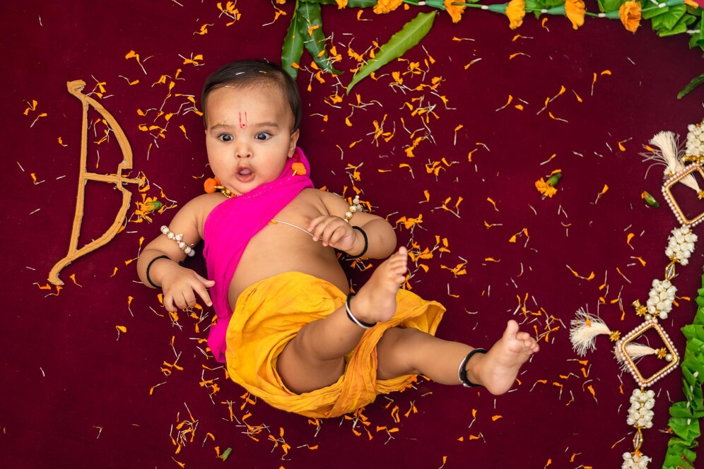 cute-indian-boy-dresses-as-lord-rama-with-bow-flowers-from-top-angle_1048944-21259336