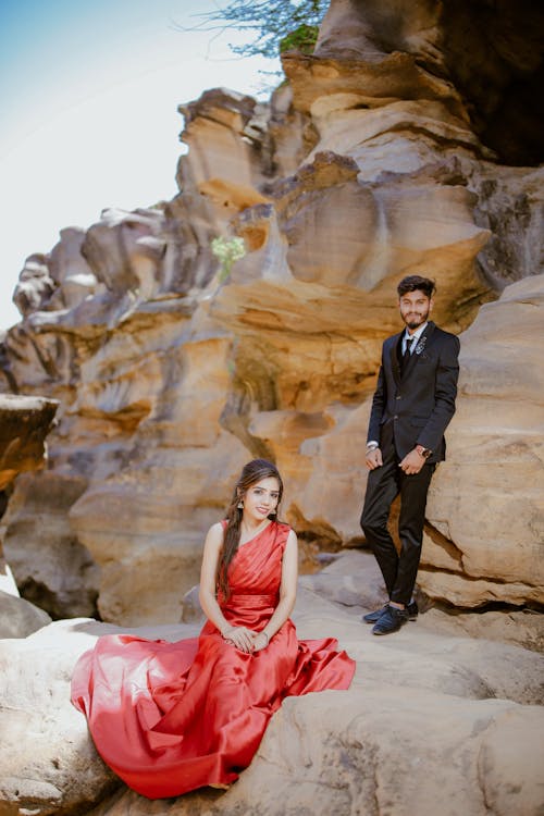 free-photo-of-couple-wearing-elegant-clothes-posing-on-a-rock-formation - Copy